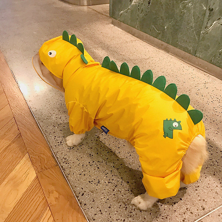 Dog wearing a yellow dinosaur costume on a stone floor.